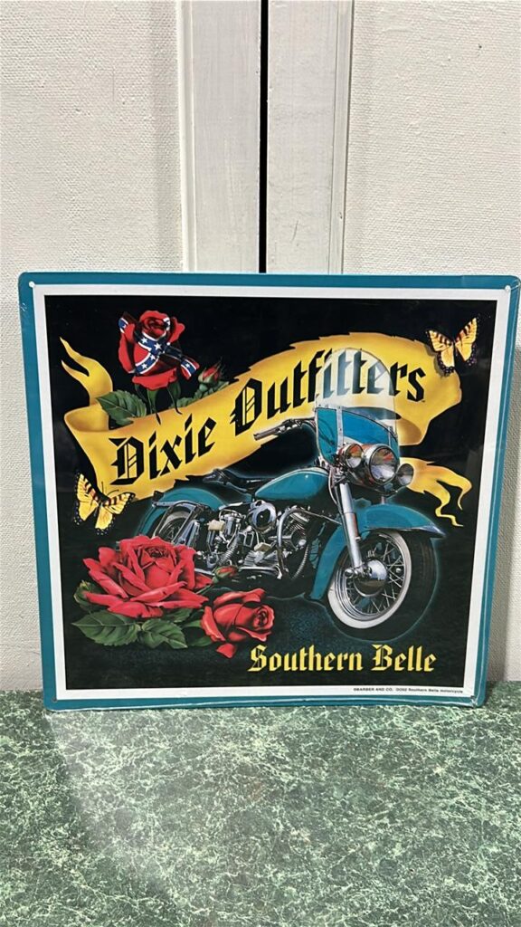 Motorcyle sign that read Dixie Outfitters and underneath the front tire of the motor cycle it reads Southern Belle