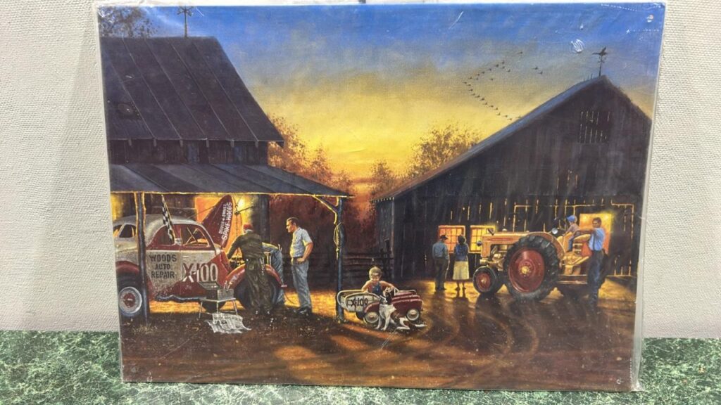 Pictire taken during dusk of 2 wooden barns with lights inside on the right is an old minneapolis moline tractor and on the right is a white truck with some decals on it. A man is stabding behind the back of the tractor and a little boy is sitting on the tractor seat. In the middle front is a little boy in a toy car. to the left there are 2 men talking by the back of the pick up truck