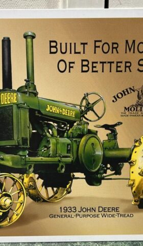 Metal square sign that reads Built for more years of Bteer Service - John Deere. The words are at the top right corner and the middle of the sign has a picture of a vintage green John Deere with yellow Steel Wheeled tractor