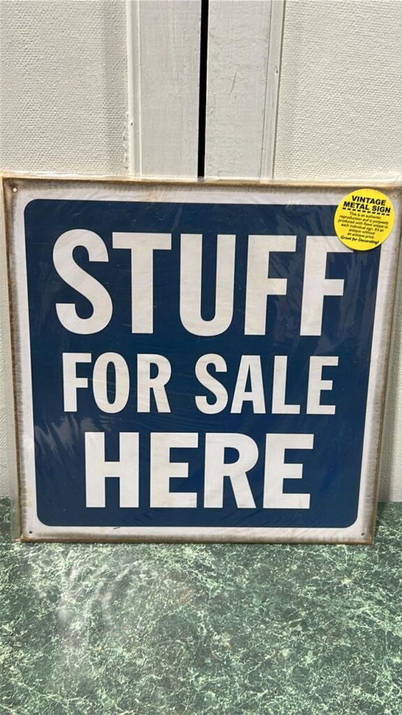 metal sign - blue background with white words that read Stuff For Sale Here with a white border around the edge of teh sign