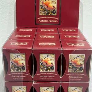 Red display box with 18 individual boxes of Autumn Avenue scented votive candles. Each box has a picture of a kid's little red wagon with 3 various size pumpkins in the wagon. The wagon is near a sidewalk that is covered with fall leaves