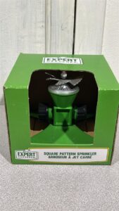 New in box Square pattern Sprinkler head. It has a green base in a green box