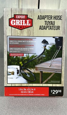 BBQ Adapter box with details of the product including that it can be attached to a 20lb propane tank and a 1lb regulator on a tale top Portable BBQ