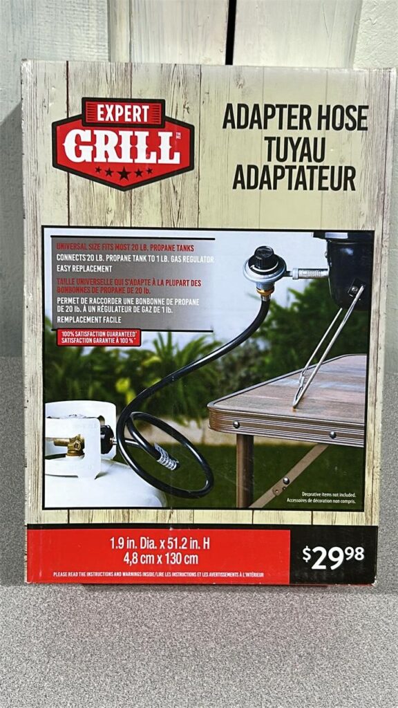 BBQ Adapter box with details of the product including that it can be attached to a 20lb propane tank and a 1lb regulator on a tale top Portable BBQ