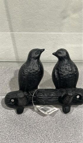 Picture of a cast iron 2 hook wall hanger that looks like 2 small birds perched facing each other on a metal branch