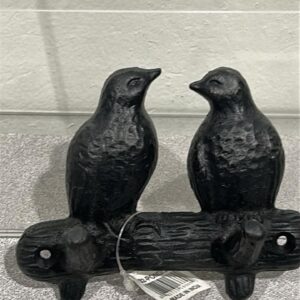 Picture of a cast iron 2 hook wall hanger that looks like 2 small birds perched facing each other on a metal branch